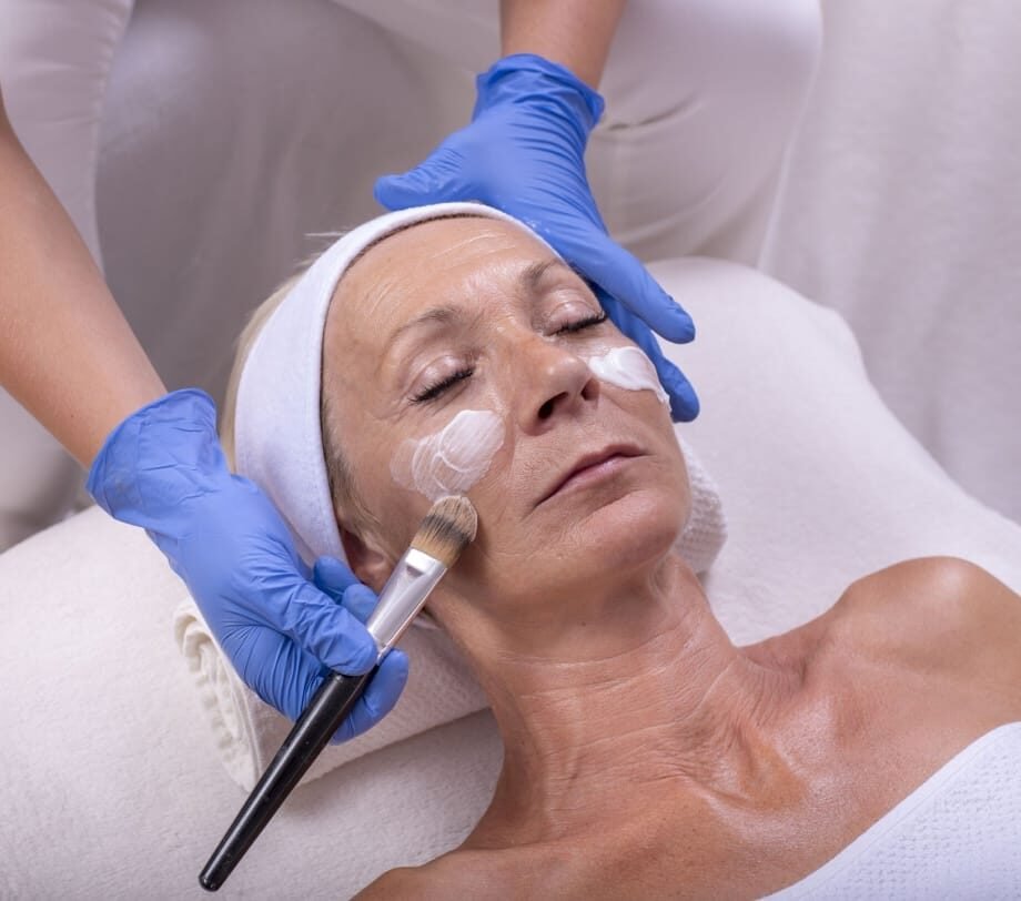 senior woman applying face cream for anti aging treatment senior woman applying face cream for anti aging treatment